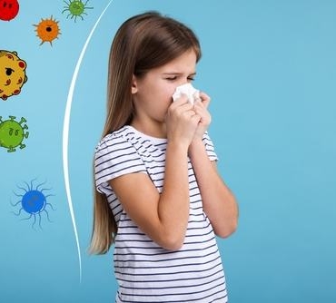 Little,Girl,With,Tissue,Sneezing,On,Light,Blue,Background.,Immunity